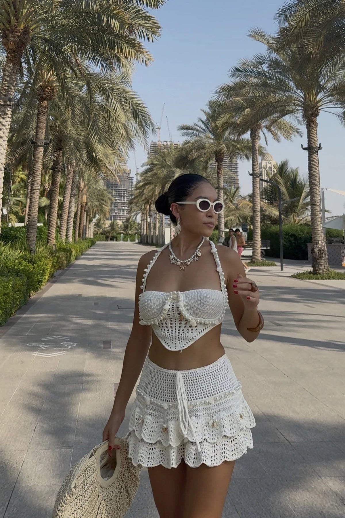 Perla set on the palm avenue with a straw bag